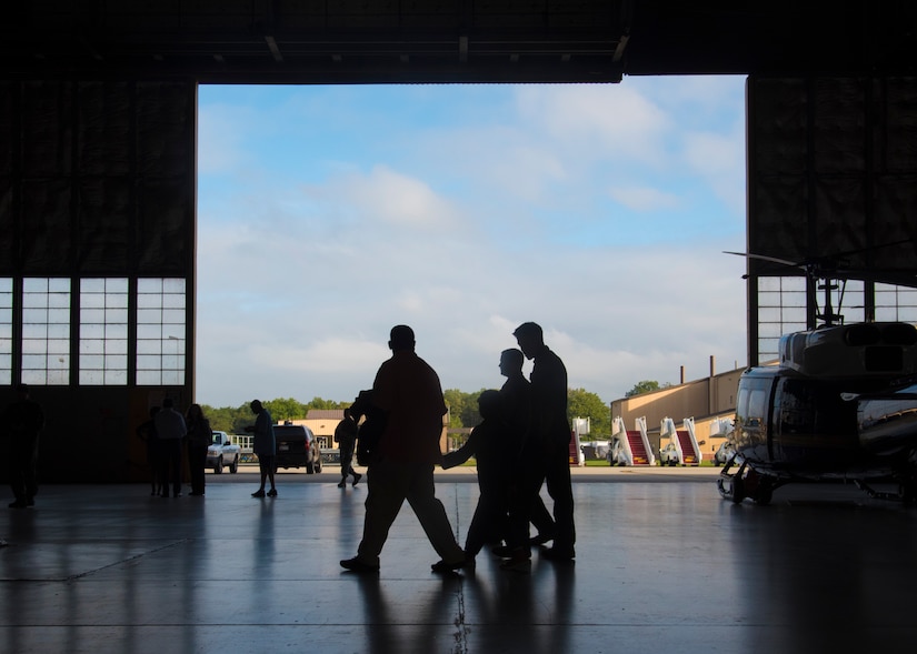 Kwami Penty and his family walk through a 1st Helicopter Squadron hangar as part of the “Pilot for a Day” program at Joint Base Andrews, Md., Oct. 6, 2016. Visiting the helicopter unit was one of many activities hosted in honor of Kwami, who is being treated for a serious illness at Children’s National Medical Center in Washington, D.C. In addition to touring the inside of a UH-1 Iroquois, Kwami was surprised with a detail of his name printed on the aircraft. (U.S. Air Force photo by Senior Airman Jordyn Fetter)