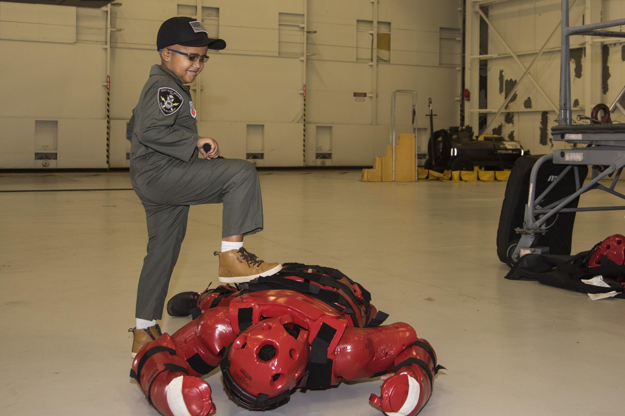 Kwami Penty uses a baton to neutralize the “redman,” or training aggressor, as part of the “Pilot for a Day” program at Joint Base Andrews, Md., Oct. 6, 2016. The security forces training component was one of many activities that filled Kwami’s day at the base. The event is held biannually to help bring joy to the lives of children with serious illnesses. (U.S. Air Force photo by Senior Airman Jordyn Fetter)