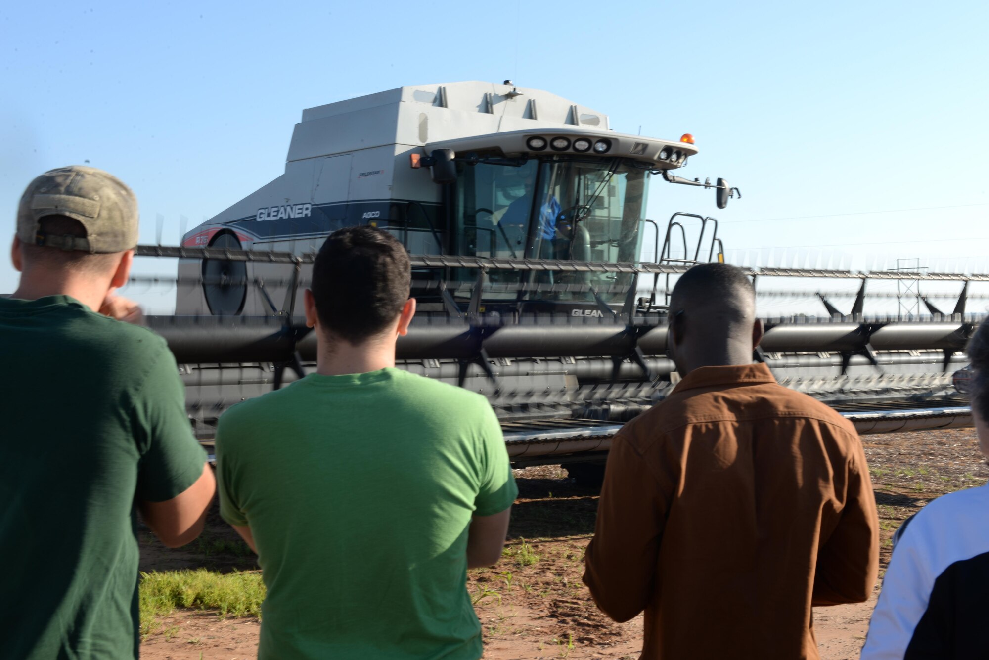Participants of the Altus Chamber of Commerce Farm City Tour watch how a combine tractor works, Oct. 3, 2016, at Bush Farms, Altus, Okla. The tour was part of 39th annual Farm City Week, which brings the business, military and farming communities closer together by highlighting the farming community of Altus. (U.S. Air Force photos by Airman First Class Cody Dowell/Released) 