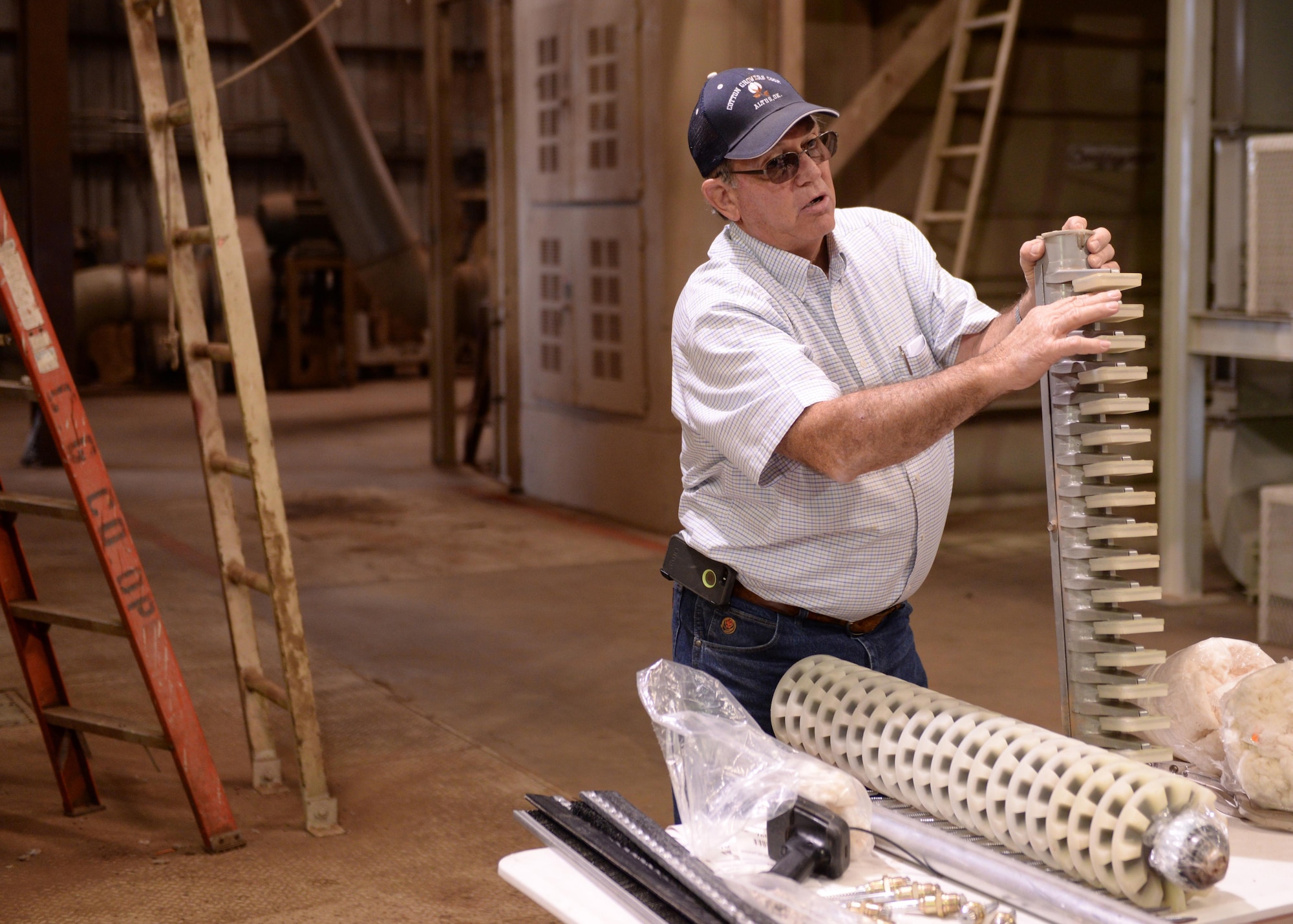 Kenneth Helton, Cotton Growers Gin assistant manager, explains the process of harvesting cotton during the Altus Chamber of Commerce Farm City Tour, Oct. 3, 2016, at Cotton Growers Gin, Altus, Okla. The tour was part of 39th annual Farm City Week, which brings the business, military and farming communities closer together by highlighting the farming community of Altus. (U.S. Air Force photos by Airman First Class Cody Dowell/Released)