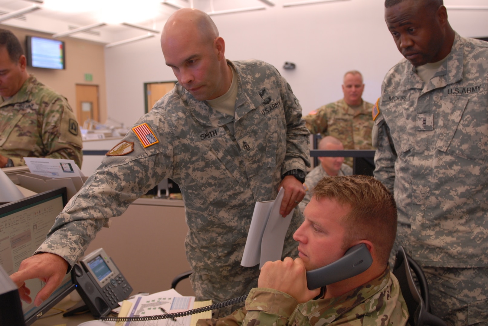 Florida National Guard Soldiers 1st Sgt Timothy Smith, Capt. Kirk Strander and CW2 Joseph McKire discuss hurricane response at the Joint Operations Center during Hurricane Matthew.