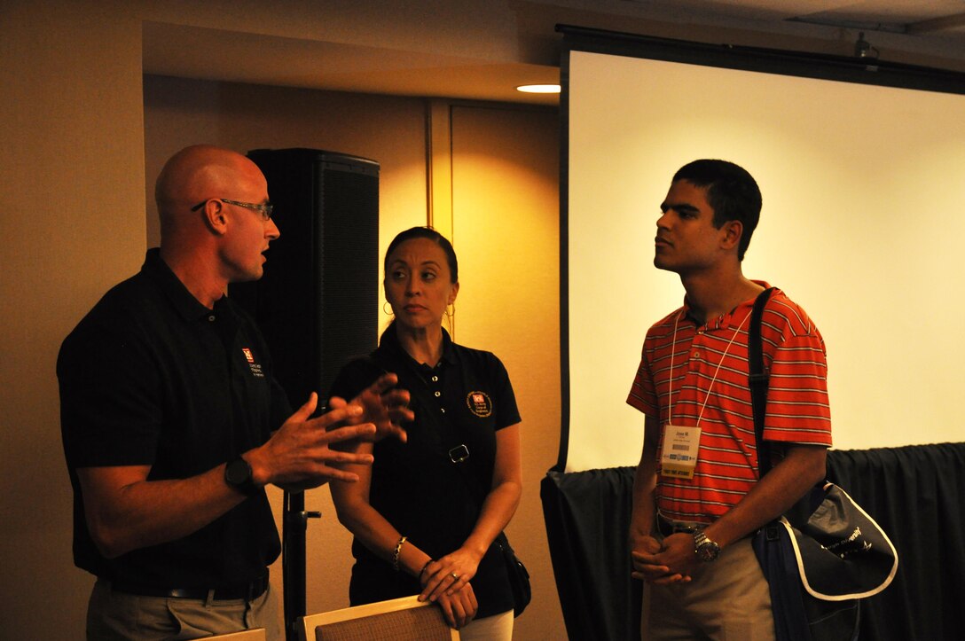 Tyler Overmire and Cecy Ordonez (left and center) talk about their work and the many job opportunities available for both engineers and non-engineers with the Corps.