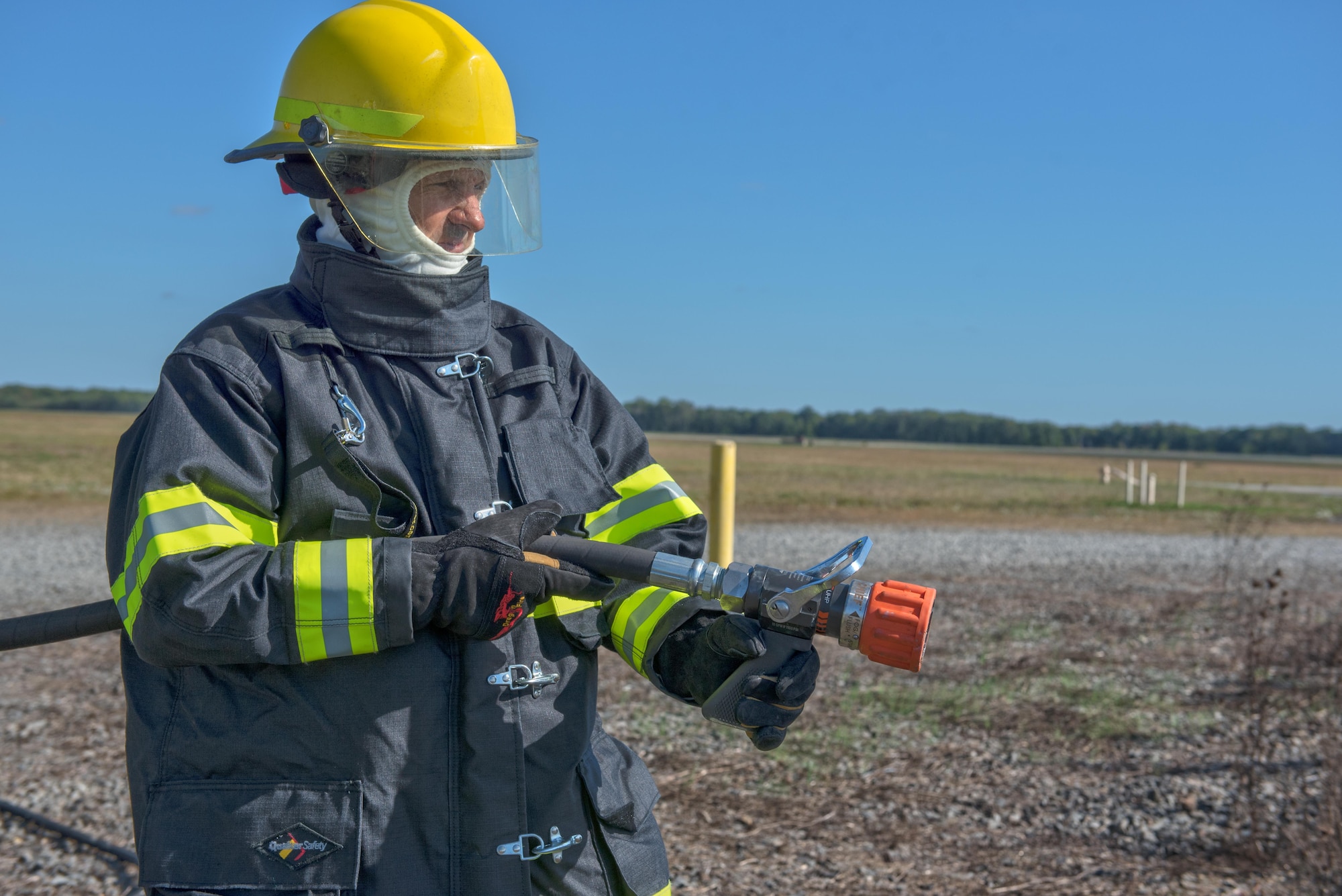 Chief Master Sgt. Craig Poling, 87th Air Base Wing command chief, prepares to fight fires on a mock aircraft at the National Fire Prevention Week kickoff at Joint Base McGuire-Dix-Lakehurst, N.J., Oct. 6. “Don’t wait – check the date!” is this year’s NFPW slogan; everyone is encouraged to check their smoke detectors and ensure their functionality and battery life.