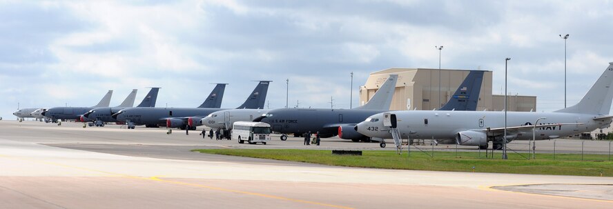 Four Navy P-8 Poseidon aircraft from Naval Air Station Jacksonville, Florida, line up with Air Force KC-135 Stratotankers on Tinker Air Force Base’s flightline Oct. 6. The P-8s, along with seven other Navy aircraft, sought shelter from Hurricane Matthew here. (Air Force photo by April McDonald)