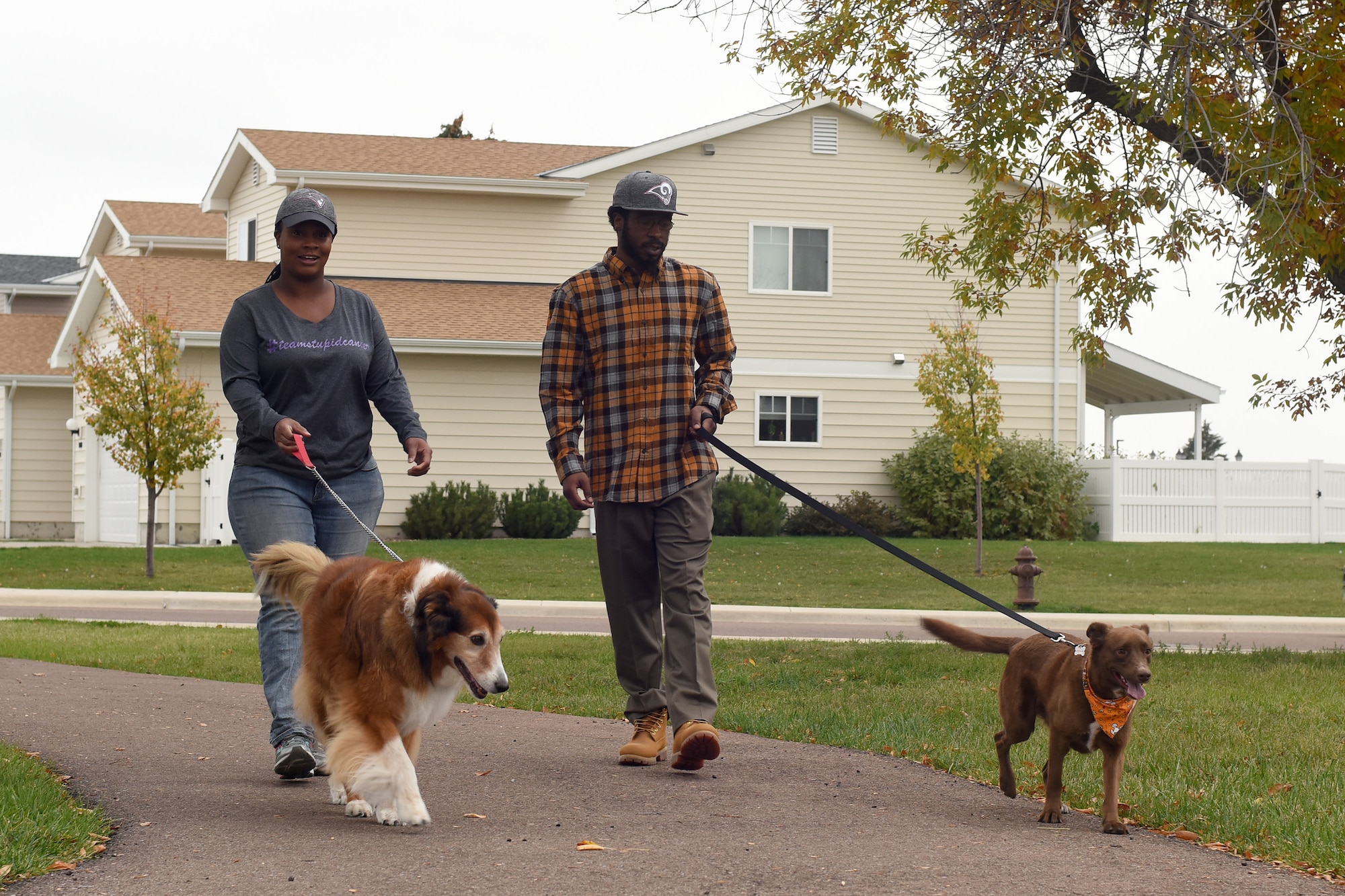 Capt. Brittany Rhanes, 341st Operations Support Squadron intercontinental ballistic missile emergency war order planner, and her husband Anthony, walk their dogs Oct. 5, 2016, at Malmstrom Air Force Base, Mont. Rhanes was diagnosed with vulvar cancer Feb. 17, 2016, and made a promise to not let that stop her. (U.S. Air Force photo/Senior Airman Jaeda Tookes)