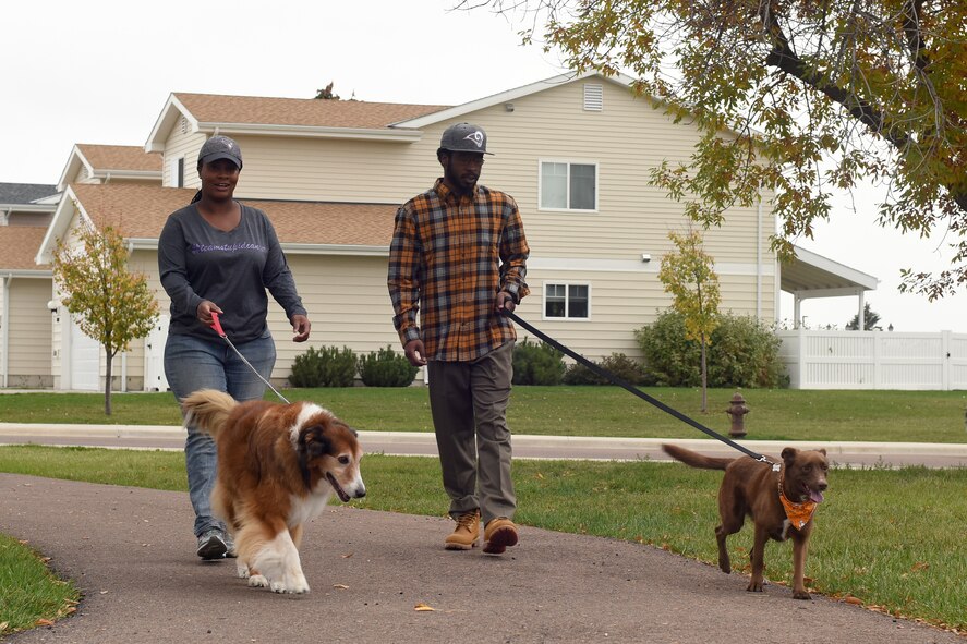Capt. Brittany Rhanes, 341st Operations Support Squadron intercontinental ballistic missile emergency war order planner, and her husband Anthony, walk their dogs Oct. 5, 2016, at Malmstrom Air Force Base, Mont. Rhanes was diagnosed with vulvar cancer Feb. 17, 2016, and made a promise to not let that stop her. (U.S. Air Force photo/Senior Airman Jaeda Tookes)