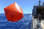 Sailors deploy an inflatable target (killer tomato) in preparation for a live fire exercise aboard the guided-missile destroyer USS Momsen (DDG 92). The guided-missile destroyers USS Spruance (DDG 111), USS Decatur (DDG 73) and Momsen are deployed in support of maritime security and stability in the Indo-Asia-Pacific as part of a U.S. 3rd Fleet Pacific Surface Action Group (PAC SAG) under Commander, Destroyer Squadron (CDS) 31. 