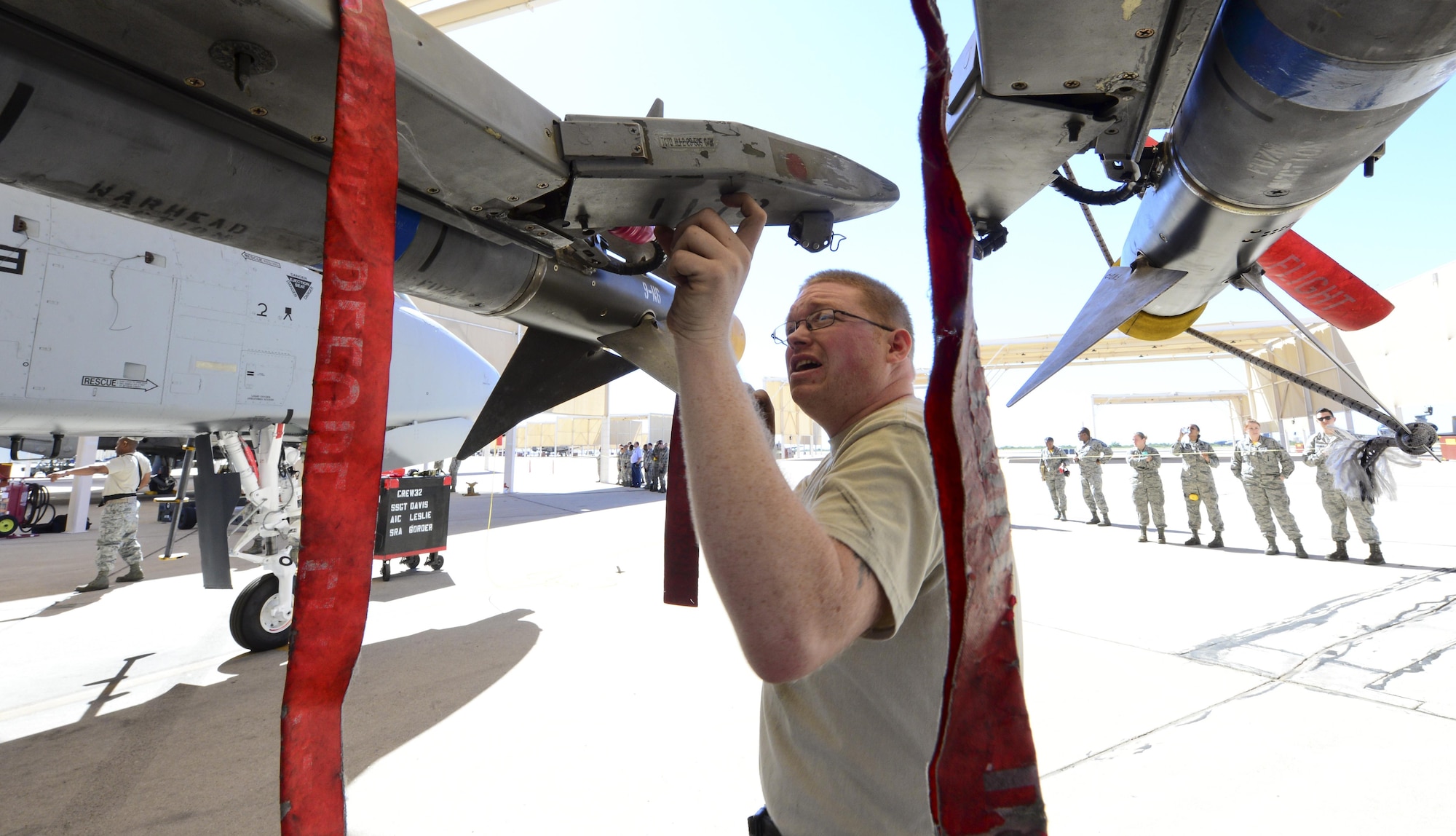 U.S. Air Force Staff Sgt. Casey Frye, 354th Aircraft Maintenance Unit weapons load crew member, inspects a missile rack after an AIM-9 Sidewinder missile was loaded onto an A-10C Thunderbolt II during a load crew of the quarter competition at Davis-Monthan Air Force Base, Ariz., Oct. 7, 2016. The load crews were evaluated based on timeliness and deficiencies during the contest. (U.S. Air Force photo by Airman Nathan H. Barbour)