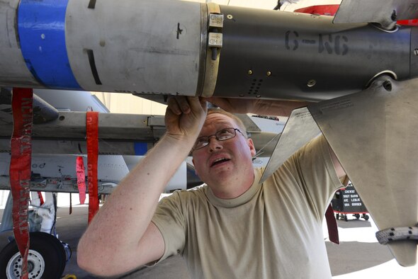 U.S. Air Force Staff Sgt. Casey Frye, 354th Aircraft Maintenance Unit weapons load crew member, inspects an AIM-9 Sidewinder missile that was loaded onto an A-10C Thunderbolt II during a load crew of the quarter competition at Davis-Monthan Air Force Base, Ariz., Oct. 7, 2016. The objective of the competition is to determine which team can most efficiently load an A-10 with munitions with the least amount of deficiencies. (U.S. Air Force photo by Airman Nathan H. Barbour)