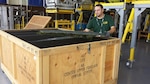 Jason Perez, 575th Aircraft Maintenance Squadron sheet metal mechanic, places a T-38 Talon II dorsal cover into a For Other Maintenance, or FOM, crate. The reusable crates are used to store parts from the aircraft during Pacer Classic III modifications. (U.S. Air Force photo by Louis Yznaga Jr.)