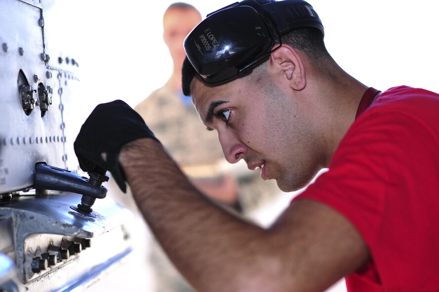 U.S. Air Force Airman 1st Class Edgar Baez-Lopez, 355th Aircraft Maintenance Squadron weapons load crew member, prepares the station of an A-10C Thunderbolt II for equipment download during a load crew competition at Davis-Monthan Air Force Base, Ariz., Oct. 7, 2016. This quarter's weapons load crew competition was between the 354th, 357th and 924th aircraft maintenance units. (U.S. Air Force photo by Senior Airman Chris Drzazgowski)