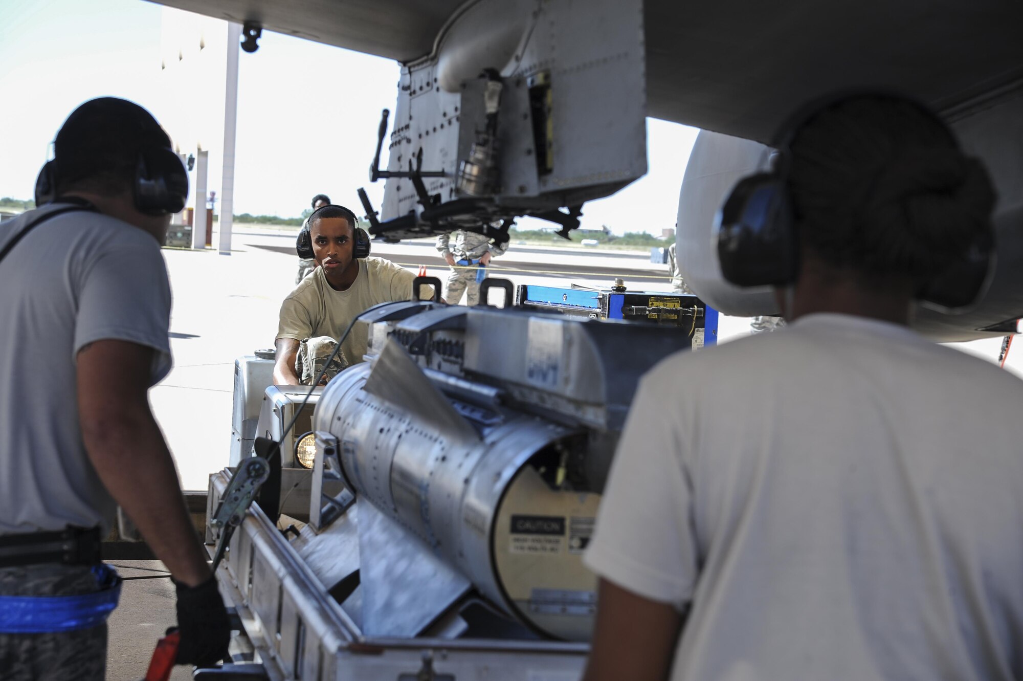 U.S. Air Force Senior Airman Jamal Williams, 354th Aircraft Maintenance Unit weapons crew member, utilizes a MHU-83 bomb loader to load an AGM-65 Maverick missile onto an A-10C Thunderbolt II during a load crew of the quarter competition at Davis-Monthan Air Force Base, Ariz., Oct. 7, 2016. The load crews were evaluated on timeliness and deficiencies during the contest. (U.S. Air Force photo by Airman 1st Class Mya M. Crosby)

