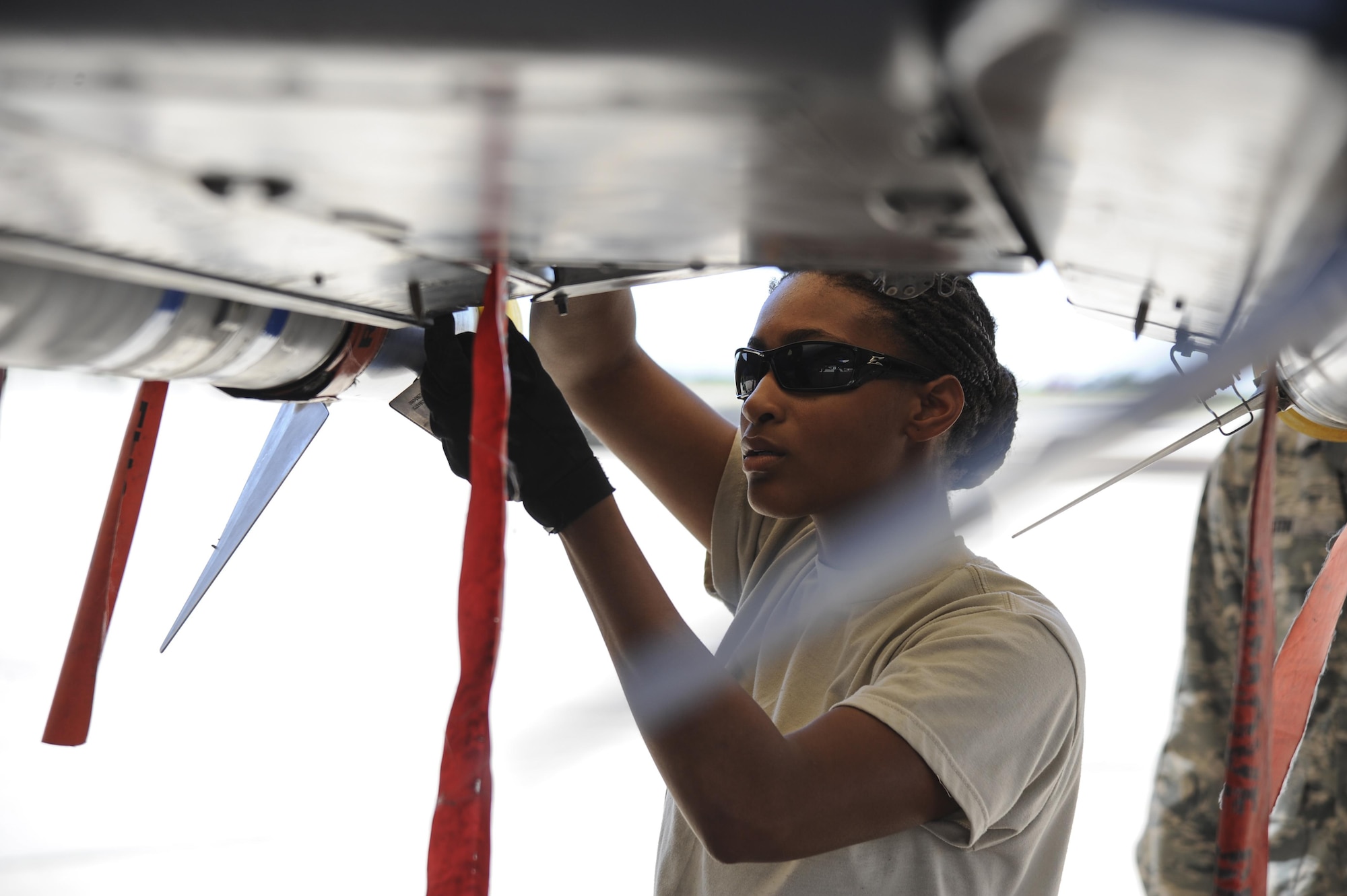 U.S. Air Force Airman Brittany Wade, 354th Aircraft Maintenance Unit weapons crew member, loads an AIM-9 Sidewinder missile onto an A-10C Thunderbolt II during a load crew of the quarter competition at Davis-Monthan Air Force Base, Ariz., Oct. 7, 2016. The objective of the contest is to determine which team can most efficiently load munitions onto an A-10. (U.S. Air Force photo by Airman 1st Class Mya M. Crosby)