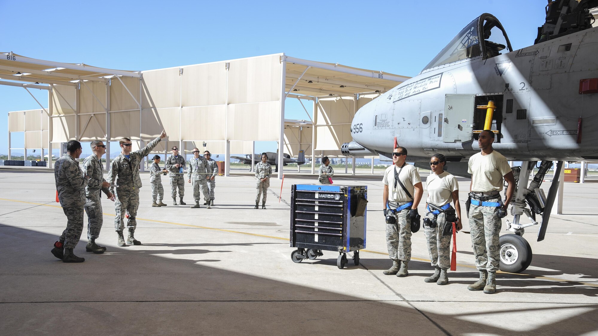U.S. Airmen assigned to the 354th Aircraft Maintenance Unit stand at attention before a load crew of the quarter competition at Davis-Monthan Air Force Base, Ariz., Oct. 7, 2016. This quarter's competition was between the 354th, 357th and 924th aircraft maintenance units. (U.S. Air Force photo by Airman 1st Class Mya M. Crosby)
