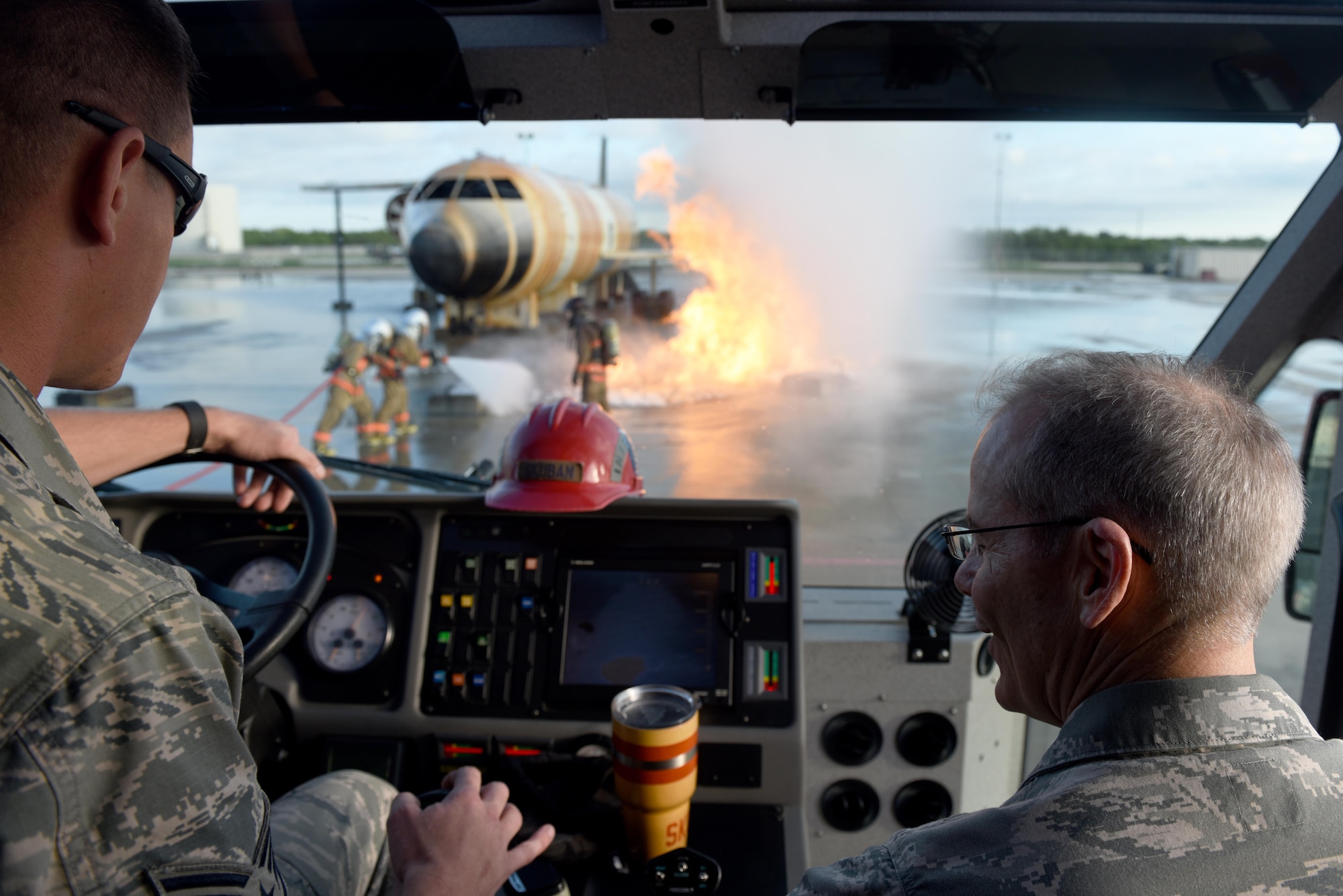 U.S. Air Force Staff Sgt. Michael Skuban, 312th Training Squadron instructor, shows Maj. Gen. Bob LaBrutta, 2nd Air Force Commander, how to use the water cannon on a fire truck at the Louis F. Garland Department of Defense Fire Academy on Goodfellow Air Force Base, Texas, Oct. 6, 2016. LaBrutta visited the training squadrons during his two-day tour of the base. (U.S. Air Force photo by Airman 1st Class Chase Sousa/Released)