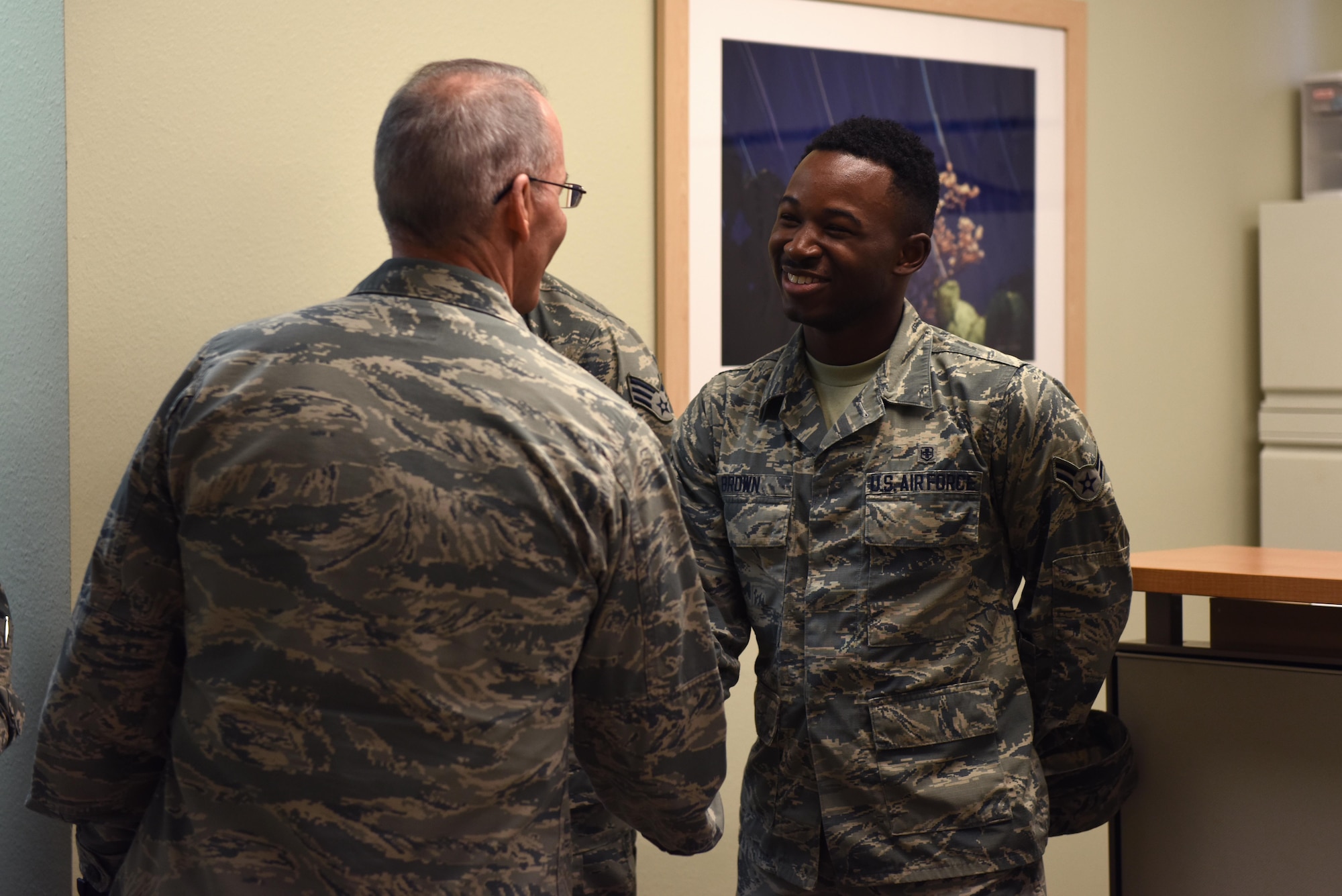 U.S. Air Force Maj. Gen. Bob LaBrutta, 2nd Air Force Commander, shakes hands with Airman 1st Class Jeremy Brown, 17th Medical Operations Squadron biological environmental engineering journeyman, at the Ross Clinic on Goodfellow Air Force Base, Texas, Oct. 6, 2016. During a two-day base tour, LaBrutta visited several buildings around base and met Airmen there. (U.S. Air Force photo by Airman 1st Class Chase Sousa/Released)