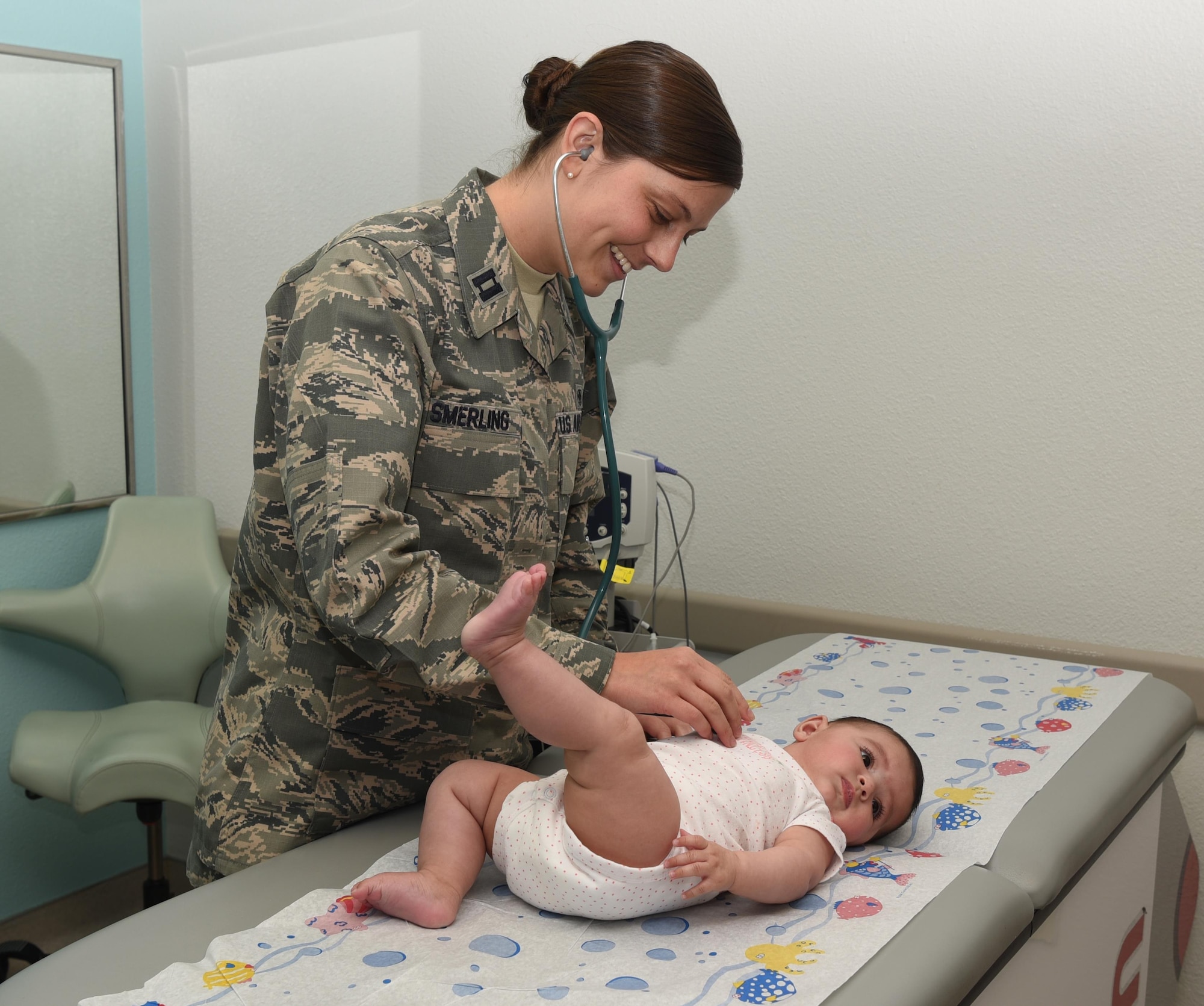 Capt. Kelly Smerling, 90th Medical Operations Squadron pediatric nurse practitioner, checks an infant’s heartbeat at F.E. Warren Air Force Base, Wyo., Sept. 29, 2016. Smerling has patients ranging from newborn to 18 years of age. (U.S. Air Force photo by Airman 1st Class Breanna Carter)