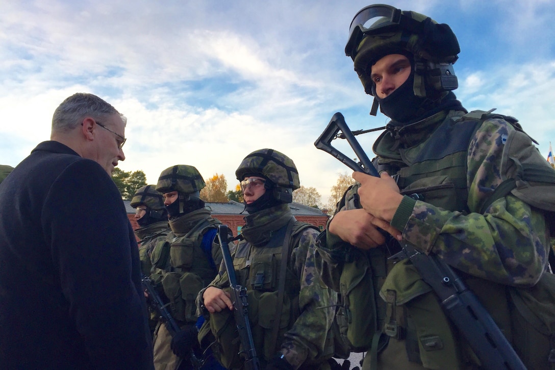 Deputy Defense Secretary Bob Work greets Finnish troops who participated in an exercise that included a beach assault and simulated intense firefights, a hostage rescue and other operations under intense conditions in Helsinki, Oct. 6, 2016. DoD photo by Lisa Ferdinando