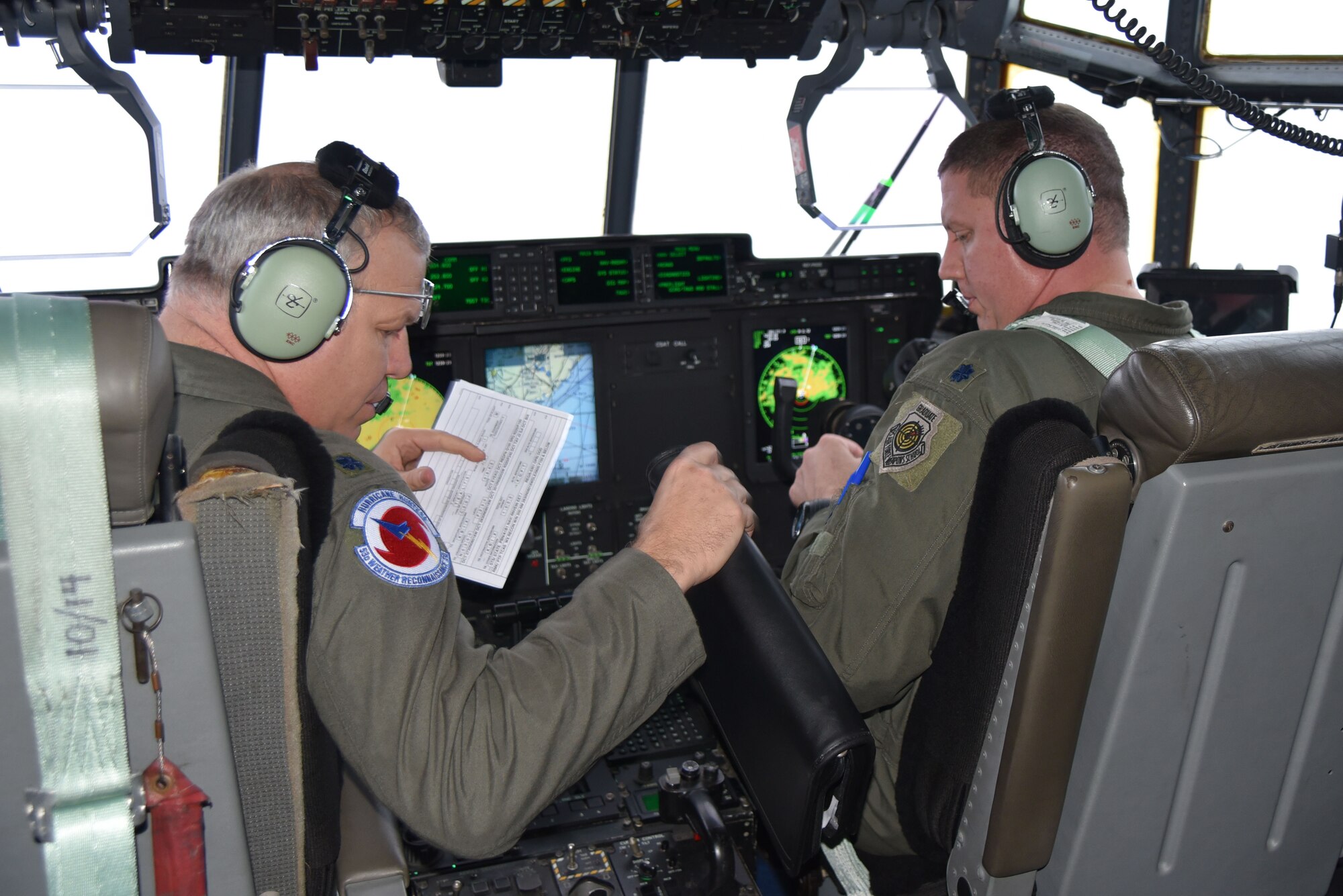 Aircraft commander Lt. Col. Dwyane Russell (left) and Lt. Col. Jim Burgess, co-pilot, fly through Hurricane Matthew Oct. 7, 2016 to collect storm data. This data is sent to the National Hurricane Center to improve forecast track and intensity models.(U.S. Air Force photo/Maj. Marnee A.C. Losurdo)

