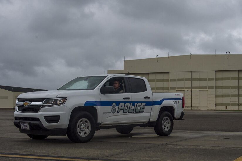 Senior Airman Tony Roybal, a patrolman with the 628th Security Forces Squadron, watches over an evacuated flightline at Joint Base Charleston, S.C., Oct. 7, 2016.  Security Forces stays vigilant during the evacuation on the base due to Hurricane Matthew. All non-essential personnel evacuated the area, but will return after disaster response coordinators assess damage and verify a safe operating environment. (U.S. Air Force photo by Airman 1st Class Sean Carnes)