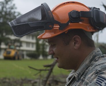 U.S. Air Force Staff Sgt. Scott Cross, a pavement and equipment craftsman assigned to the 628th Civil Engineer Squadron, takes a breath after felling a dead tree ahead of Hurricane Matthew at Joint Base Charleston, S.C., Oct. 7, 2016. All non-essential personnel evacuated the area, but will return after disaster response coordinators assess damage and verify a safe operating environment. (U.S. Air Force photo by Tech. Sgt. Barry Loo)