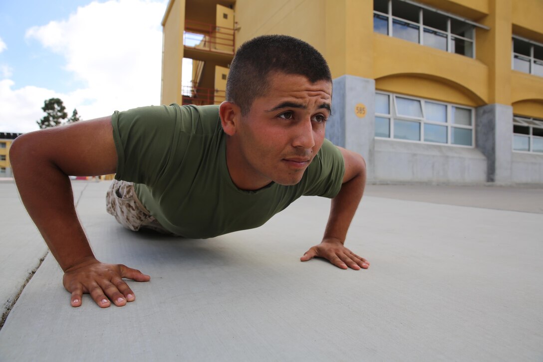 Private Jonsebastian Andrade, Lima Company, 3rd Recruit Training Battalion, executes a push-up outside of his squad bay at Marine Corps Recruit Depot San Diego, Oct. 4. Prior to arriving to recruit training, Andrade was required to lose 60 pounds in order to enlist in the Marine Corps. Annually, more than 17,000 males recruited from the Western Recruiting Region are trained at MCRD San Diego. Lima Company is scheduled to graduate Oct. 7.