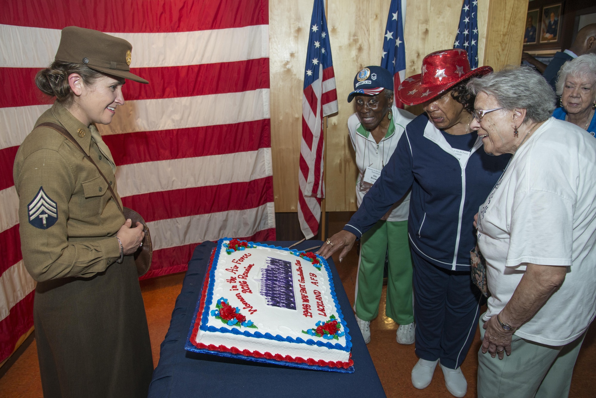 Members of the Women in the Air Force, the term for women who joined the Air Force between the years of 1949 -1976, view a celebratory cake with a photo of the first all-female Air Force basic Military Training Class during the Joint Base San Antonio WAF Reunion Oct. 7 at JBSA-Lackland. WAF was founded in 1948 out of the Women’s Armed Service Integration Act, which enabled tens of thousands of female service members to find jobs in the Air Force. In 1976 women were accepted into the service on an equal basis with men. 