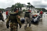 A search and rescue team with the Florida  National Guard wades into areas in St. Augustine, Florida, affected by Hurricane Matthew to assist with disaster relief efforts. More than 9000 Guard members are on duty throughout Florida, Georgia and the Carolinas assisting state and local authorities with search and rescue and relief operations. 