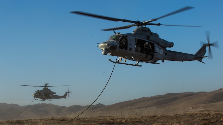 Two UH-1Y Hueys with Marine Light Attack Helicopter Squadron 369 hover above the ground while Marines with 1st Reconnaissance Battalion, 1st Marine Division, conduct fast-rope training at Marine Corps Base Camp Pendleton, California, Oct. 3, 2016.  Fast roping was part of a larger event called a Marine Air-Ground Task Force integration exercise, which enabled air and ground units to come together and cooperate in various training missions prior to their deployment with the 15th Marine Expeditionary Unit.