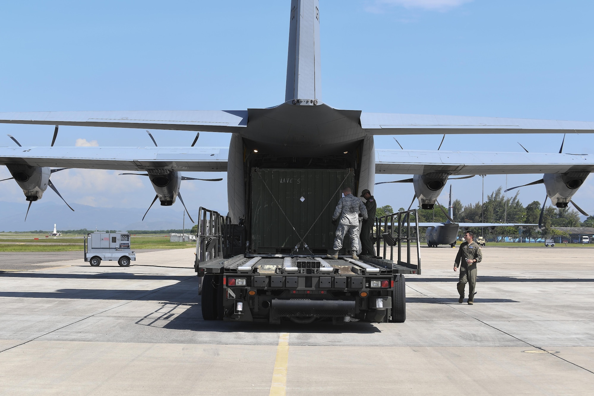U.S. Air Force Staff Sgt. Dustin Jett, 612th Air Base Squadron senior information controller, helps aircrew members from Dyess Air Force Base, Texas load a “conex” box onto a C-130J Hercules at Soto Cano Air Base, Honduras, Oct. 7, 2016. U.S. Southern Command requested heavy airlift to transport critical equipment packages needed to sustain helicopter flight operations in Haiti being conducted by Special Purpose Marine Air-Ground Task Force-Southern Command and Joint Task Force-Bravo’s 1st Battalion, 228th Aviation Regiment using two CH-53E Super Stallions, three CH-47 Chinooks, and two UH-60L and two HH-60L Black Hawks in support of the U.S. Agency for International Development-led mission to alleviate human suffering and bolster Haitian disaster response capabilities.