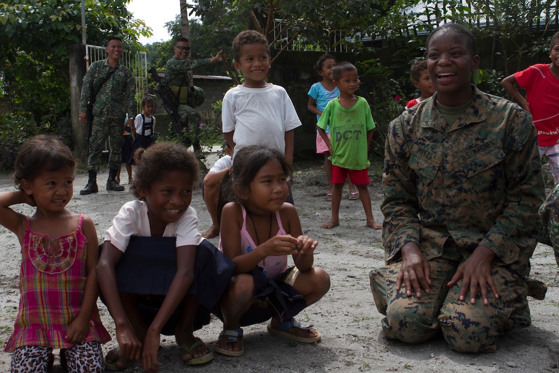 U.S. Marine Lance Cpl. Maresea Potts, a supply clerk with Combat Logistics Battalion 31, 31st Marine Expeditionary Unit, plays a game of Duck-Duck-Goose with Maruglo Elementary School students during a visit to the school on Col. Ernesto Ravina Air Base, Philippines, Oct. 6, 2016. Marines and Sailors with the 31st MEU visited the school to build unity between U.S. forces and the local residents during Philippine Amphibious Landing Exercise 33 (PHIBLEX). PHIBLEX is an annual U.S.-Philippine military bilateral exercise that combines amphibious capabilities and live-fire training with humanitarian civic assistance efforts to strengthen interoperability and working relationships. (U.S. Marine Corps Photo by Staff Sgt. T.T. Parish/Released) 