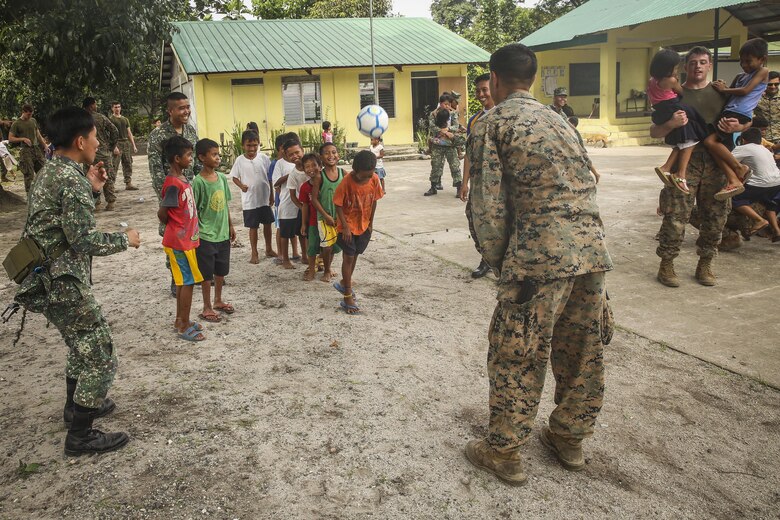 U.S. Marines with Battalion Landing Team, 2nd Battalion, 4th Marine Regiment, 31st Marine Expeditionary Unit, meet, greet and play games with Filipino children during a visit to a local school during Philippine Amphibious Landing Exercise 33 (PHIBLEX) on Col. Ernesto Ravina Air Base, Philippines, October 6, 2016. PHIBLEX is an annual U.S.-Philippine military bilateral exercise which combines amphibious capabilities and live-fire training with humanitarian civic assistance efforts to strengthen interoperability and working relationships. (U.S. Marine Corps photo by Lance Cpl. Jay A. Parks/Released)