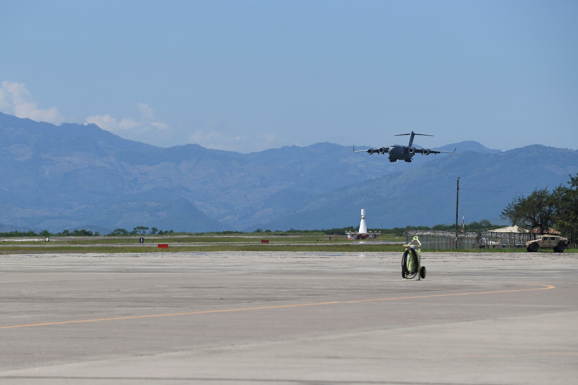 A C-17 Globemaster III from Dover Air Force Base, Del., prepares to land at Soto Cano Air Base, Honduras, Oct. 6, 2016, prior to deploying to Haiti to support the ongoing Hurricane Matthew disaster relief efforts. The aircraft and crew from Dover Air Force Base, Delaware, deployed to Soto Cano within hours of being requested by U.S. Southern Command to transport additional personnel and equipment necessary to sustain flight and maintenance operations for to support Joint Task Force Matthew hurricane relief operations where approximately 200 Soldiers, Airmen and Marines from Special Purpose Marine Air-Ground Task Force-Southern Command and Joint Task Force-Bravo deployed this week with two CH-53E Super Stallion, three CH-47 Chinook, and two UH-60L and two HH-60L Black Hawk helicopters to provide heavy and medium lift to support the U.S. Agency for International Development-led mission.