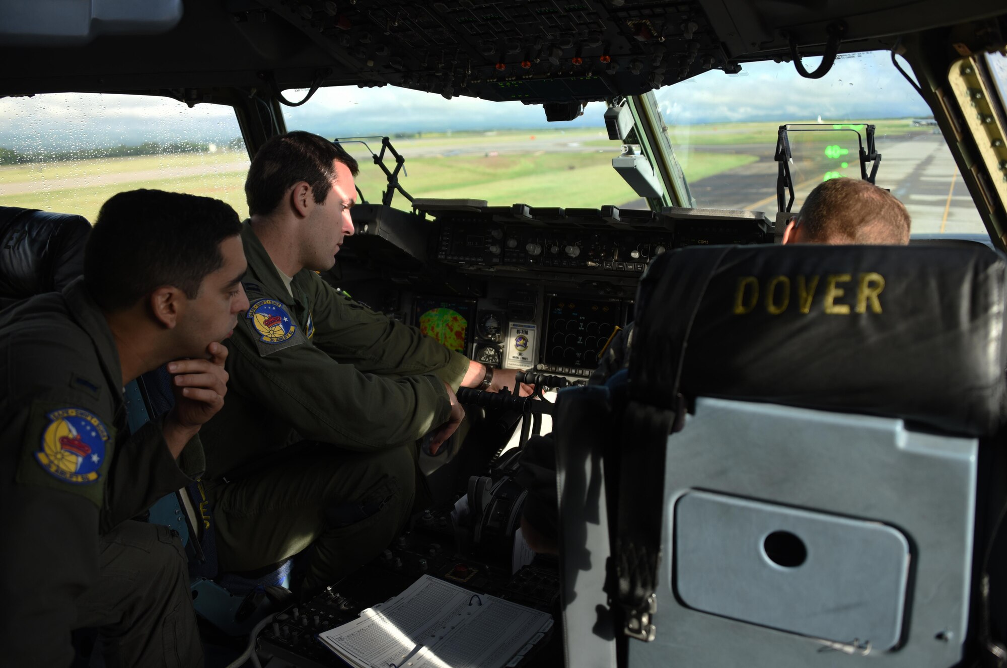 U.S. Air Force 1st Lt. Ben Bertelson, observes as U.S. Air Force Capt. Mike Kieffabar, both 3rd Airlift Squadron pilots, reviews the final mission plan for their flight to Port-au-Prince, Haiti from Soto Cano Air Base, Honduras, Oct. 8, 2016. The aircraft and crew from Dover Air Force Base, Delaware, deployed to Soto Cano within hours of being requested by U.S. Southern Command to transport additional personnel and equipment necessary to sustain flight and maintenance operations for to support Joint Task Force Matthew hurricane relief operations where approximately 200 Soldiers, Airmen and Marines from Special Purpose Marine Air-Ground Task Force-Southern Command and Joint Task Force-Bravo deployed this week with two CH-53E Super Stallion, three CH-47 Chinook, and two UH-60L and two HH-60L Black Hawk helicopters to provide heavy and medium lift to support the U.S. Agency for International Development-led mission. (U.S. Air Force photo by Capt. David Liapis)