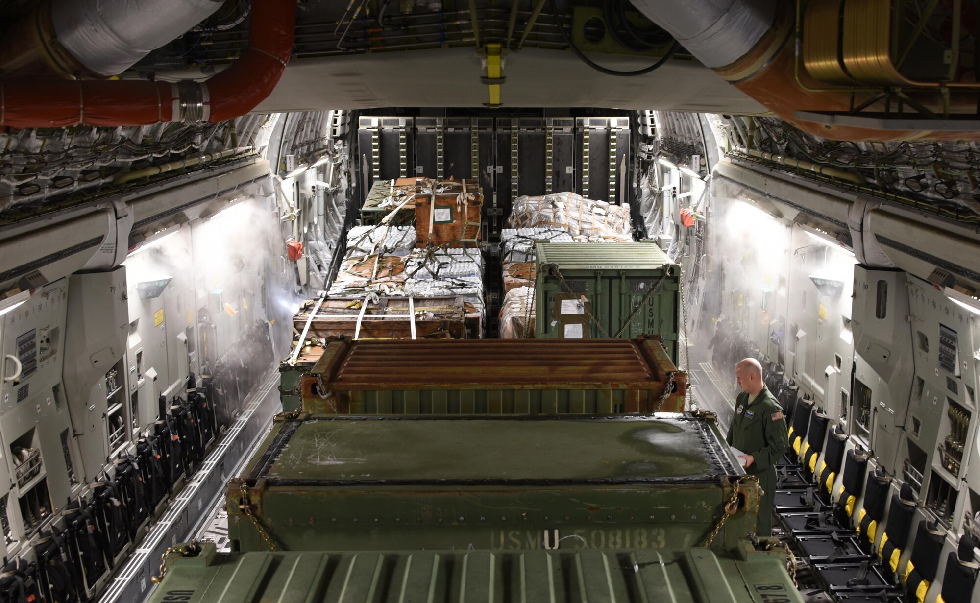 U.S. Air Force Staff Sgt. Daniel Matthews, 3rd Airlift Squadron loadmaster, inspects cargo that was loaded on a C-17 Globemaster III cargo aircraft at Soto Cano Air Base, Honduras, before taking off for Port-au-Prince, Haiti where the equipment will be used to support Joint Task Force Matthew hurricane relief operations, Oct. 8, 2016. U.S. Southern Command requested heavy airlift to transport critical equipment packages needed to sustain helicopter flight operations in Haiti being conducted by Special Purpose Marine Air-Ground Task Force-Southern Command and Joint Task Force-Bravo’s 1st Battalion, 228th Aviation Regiment using two CH-53E Super Stallions, three CH-47 Chinooks, and two UH-60L and two HH-60L Black Hawks in support of the U.S. Agency for International Development-led mission to alleviate human suffering and bolster Haitian disaster response capabilities. (U.S. Air Force photo by Capt. David Liapis)