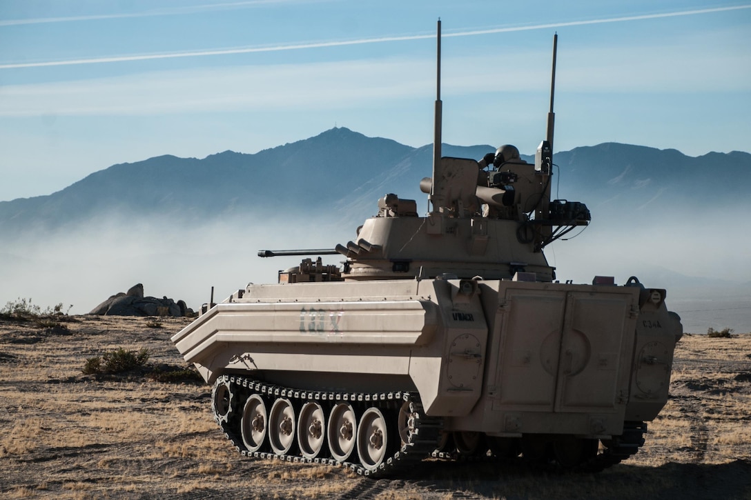 A soldier in an opposing-forces surrogate vehicle surveys the battlefield during a rotation at the National Training Center at Fort Irwin, Calif., Oct. 7, 2016. The soldier is assigned to 1st Squadron, 11th Armored Cavalry Regiment. The rotation focused on the brigade's ability to conduct a deliberate defense of an area during conventional and hybrid threats. Army photo by Sgt. David Edge