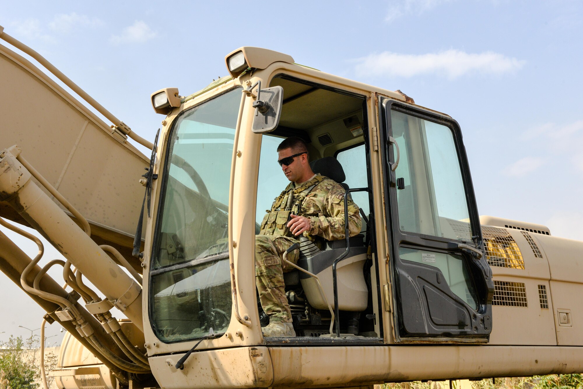 Master Sgt. Thomas Ryan, Train, Advise, Assist Command-Air (TAAC-Air) civil engineer advisor, operates an excavator while clearing reeds from a field at Kabul Air Wing, Afghanistan, Oct. 6, 2016. Ryan cleared an area about 350-meters long, 20-meters wide and 7-meters deep of reeds that had grown in excess of 15 feet tall. (U.S. Air Force photo by Tech. Sgt. Christopher Holmes)