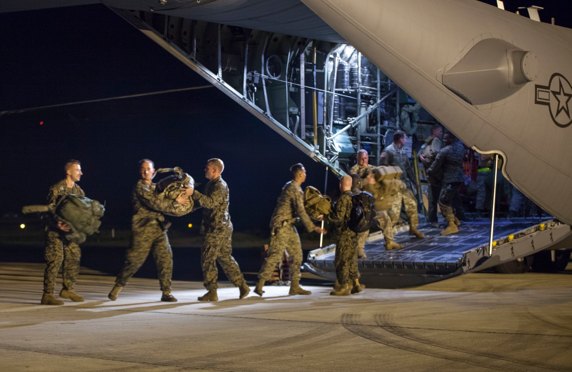 U.S. Marines with Special Purpose Marine Air-Ground Task Force - Southern Command and soldiers from 1st Battalion, 228th Aviation Regiment unload an Ohio Air National Guard C-130H Hercules after arriving in Port-au-Prince, Haiti, ready to support the humanitarian assistance and disaster relief effort in response to Hurricane Matthew, Oct. 5, 2016. The service members of SPMAGTF-SC and 1st Battalion, 228th Aviation Regiment are part of Joint Task Force Matthew, a U.S. Southern Command-directed response team deployed to support U.S. disaster relief operations in the Caribbean in response to Hurricane Matthew. (U.S. Marine Corps photo by Sgt. Adwin Esters) 