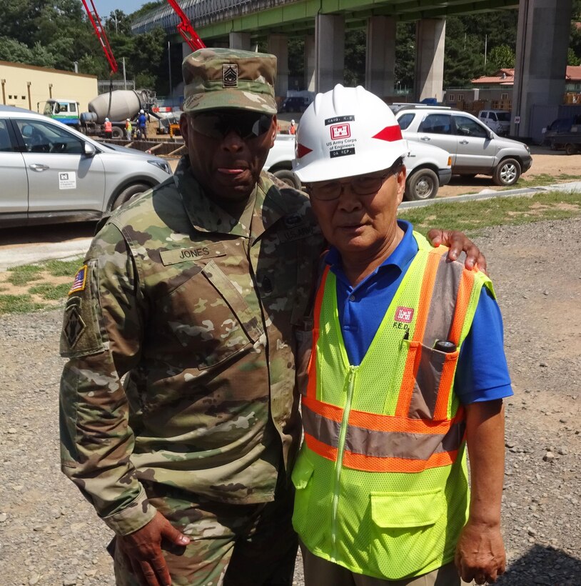 Kang Kil-su, quality assurance representative for the southern resident office, with U.S. Army Corps of Engineers Command Sgt. Maj. Antonio S. Jones. 