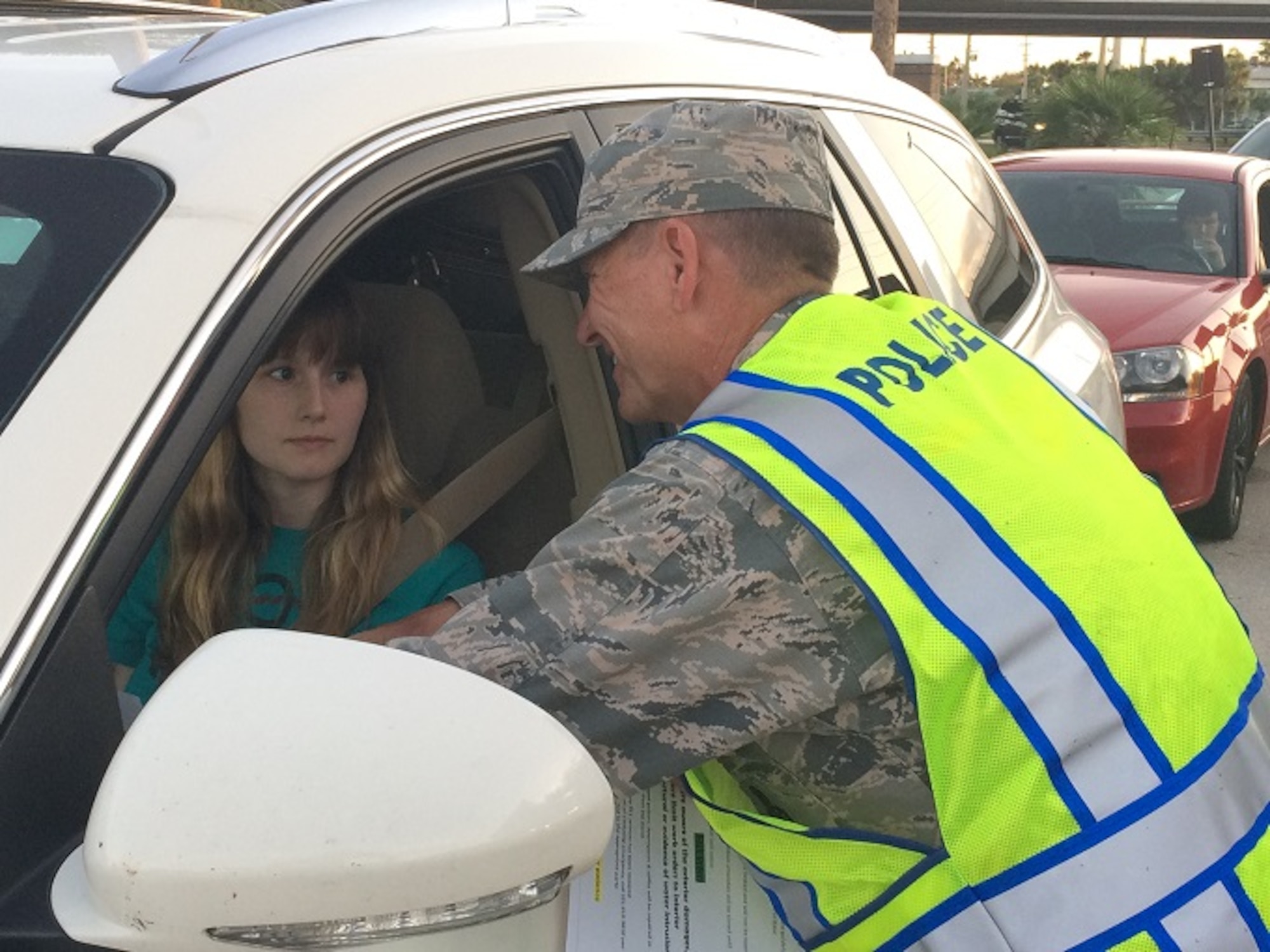 Brig. Gen. Wayne Monteith, 45th Space Wing Commander, welcomes Airman 1st Class Samantha Westerman, 45th Aerospace Medicine Squadron’s Public Health Flight, at the South Gate as she returns back on base after Hurricane Matthew Oct. 8, 2016. Monteith spent more than eight hours personally thanking residents for their patience and positive attitude for weathering the storm with the wing team.  The general had a first-hand look at everyone's personal well-being and an opportunity to provide them an informational handout on base safety concerns and the boil water notice. Westerman was pleasantly surprised to see the Wing Commander at the gate and praised the level of communication she received throughout the storm. (U.S. Air Force Photo/Shawn Walleck)