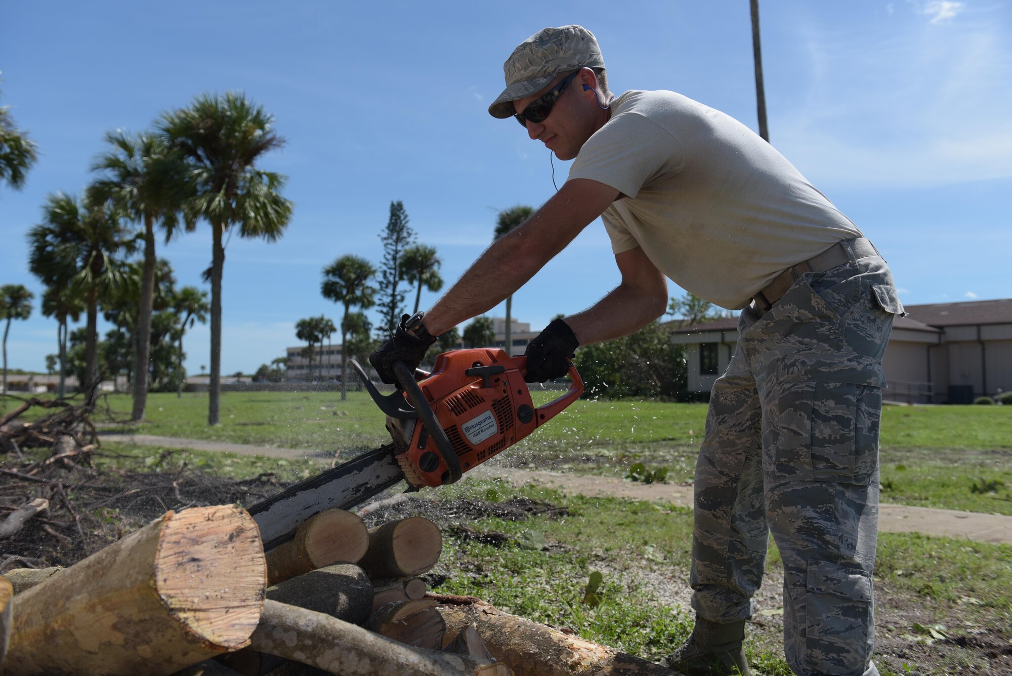 Staff Sgt. Micky Stoner, of the 45th Civil Engineer Squadron, cuts limbs of fallen trees during the 45th Space Wing’s Hurricane Matthew recovery efforts Oct. 8, 2016, at Patrick Air Force Base, Fla. Hurricane Recovery Teams for Patrick AFB and Cape Canaveral Air Force Station worked around the clock to assess and repair storm damage until the installations opened when other personnel were able to return and augment the teams. (U.S. Air Force photo/Derwin Oviedo)