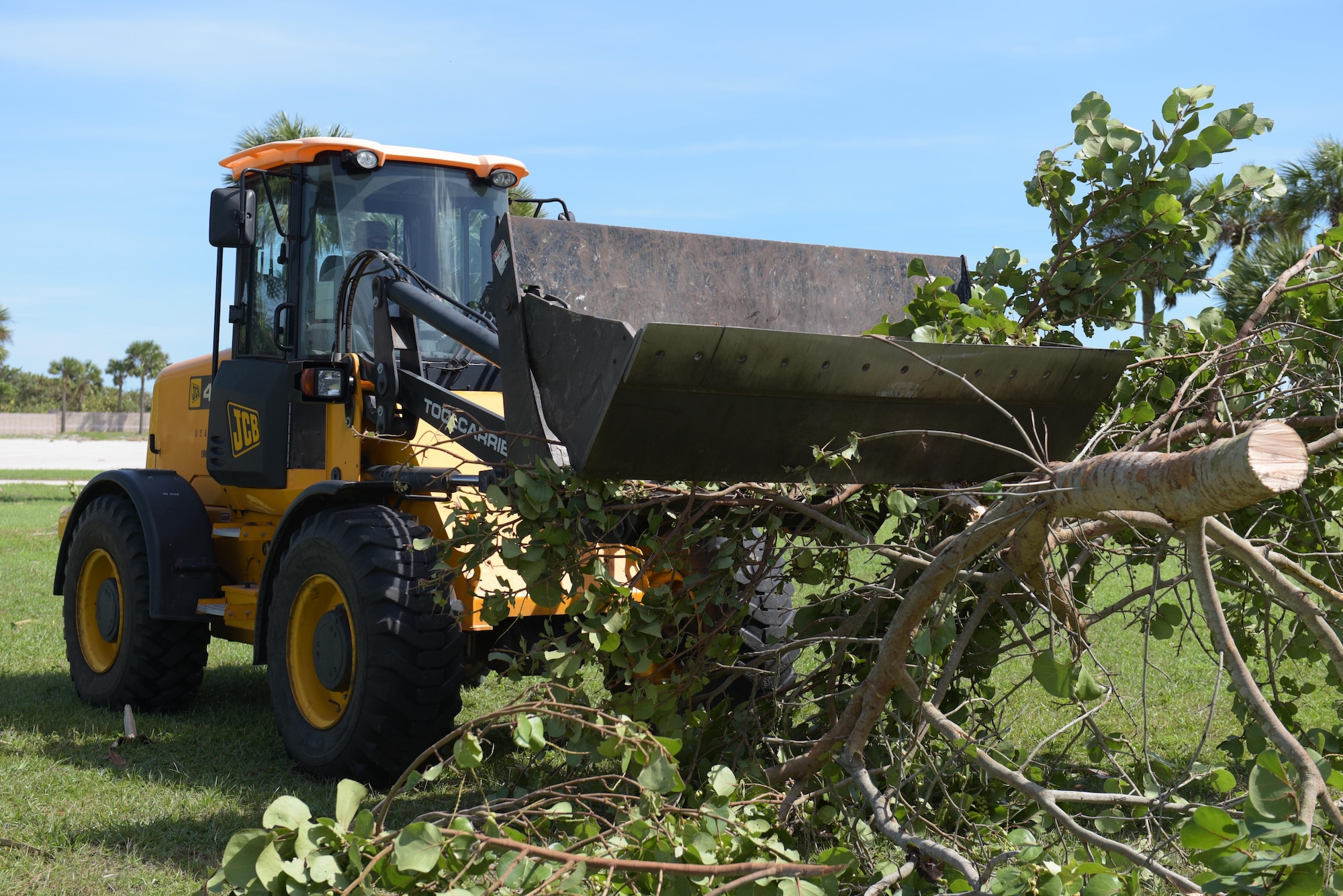 Tech. Sgt. Chad King, 45th Civil Engineer Squadron heavy equipment operator, collects debris during the 45th Space Wing’s Hurricane Matthew recovery efforts Oct. 8, 2016, at Patrick Air Force Base, Fla. Hurricane Recovery Teams for Patrick AFB and Cape Canaveral Air Force Station deployed to an alternate location prior to the storm and remained on call to help with immediate assessment repair after the storm. (U.S. Air Force photo/Derwin Oviedo)