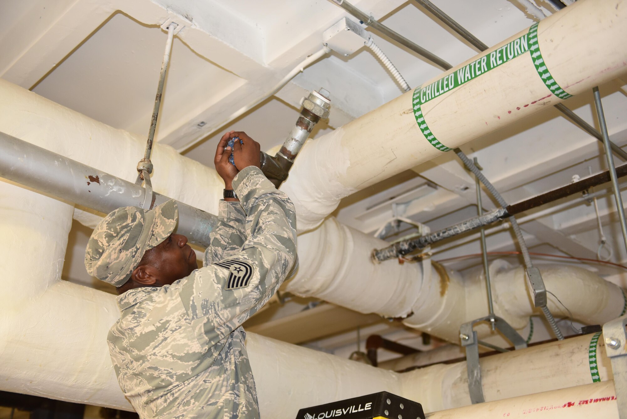 Tech. Sgt. Donrico Hooker, 45th Civil Engineer Squadron, turns a valve on a water chiller pump to bleed air through the Heating, Ventilation and Air Conditioning System in the headquarters building Oct. 8, 2016, at Patrick Air Force Base, Fla.  The 45th Space Wing’s hurricane recovery teams, made up of more than 175 personnel have been working around the clock to assess and repair damage on base. The 45th SW returned to normal operations within three days following the storm. (U.S. Air Force photo/Derwin Oviedo)