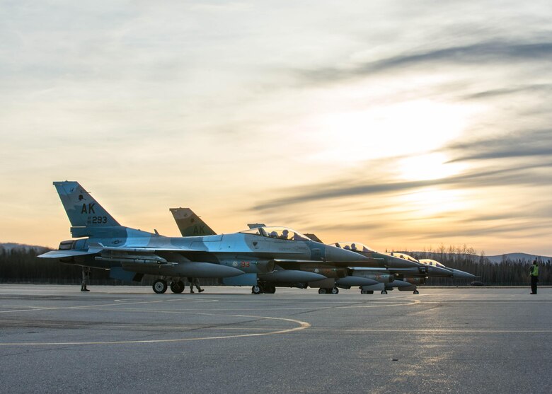 Pilots from the 18th Aggressor Squadron prepare to take off in F-16 Fighting Falcon aircraft after finishing end of runway checks Oct. 10, 2016, during RED FLAG-Alaska 17-1 at Eielson Air Force Base, Alaska. Exercise scenarios occur within the Joint Pacific Alaska Range Complex, a more than 67,000 square mile airspace with minimal impact on the environment. (U.S. Air Force photo by Staff Sgt. Shawn Nickel)
