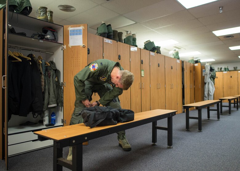 U.S. Air Force Col. David Mineau, the 354th Fighter Wing commander, dresses for a mission Oct. 10, 2016, during RED FLAG-Alaska 17-1 at Eielson Air Force Base, Alaska. This Pacific Air Forces commander-directed exercise is vital to maintaining peace and stability in the Indo-Asia-Pacific region. (U.S. Air Force photo by Staff Sgt. Shawn Nickel)
