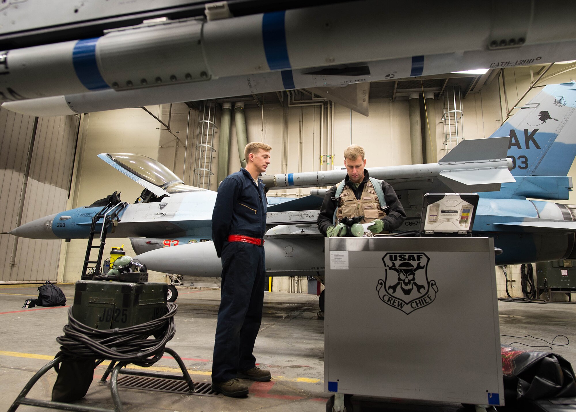U.S. Air Force Airman 1st Class Spencer Hall, a 354th Aircraft Maintenance Squadron crew chief, briefs Col. David Mineau, the 354th Fighter Wing commander, on the maintenance records of the F-16 Fighting Falcon aircraft he prepares to fly for a sortie Oct. 10, 2016, during RED FLAG-Alaska (RF-A) 17-1 at Eielson Air Force Base, Alaska. The F-16 Fighting Falcon is a compact multi-role fighter aircraft, which the 18th Aggressor Squadron uses to simulate adversaries during RF-A. (U.S. Air Force photo by Staff Sgt. Shawn Nickel)

