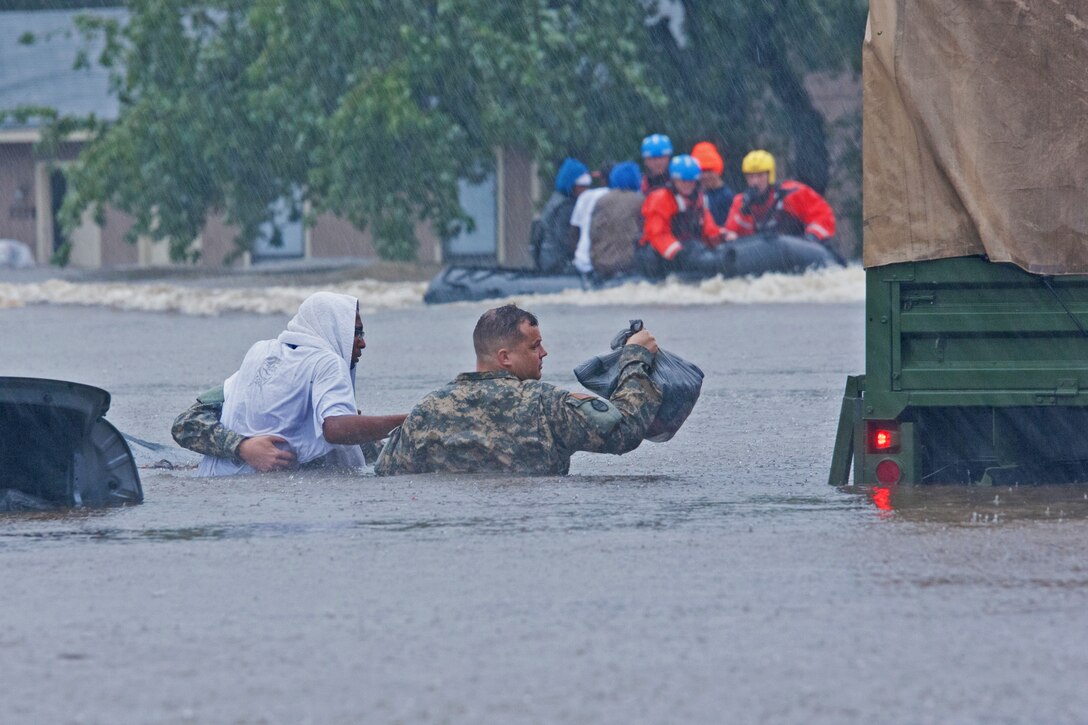 North Carolina Army National Guardsmen and local emergency services assist with evacuation efforts during Hurricane Matthew in Fayetteville, N.C., Oct. 8, 2016. Army National Guard photo by Staff Sgt. Jonathan Shaw