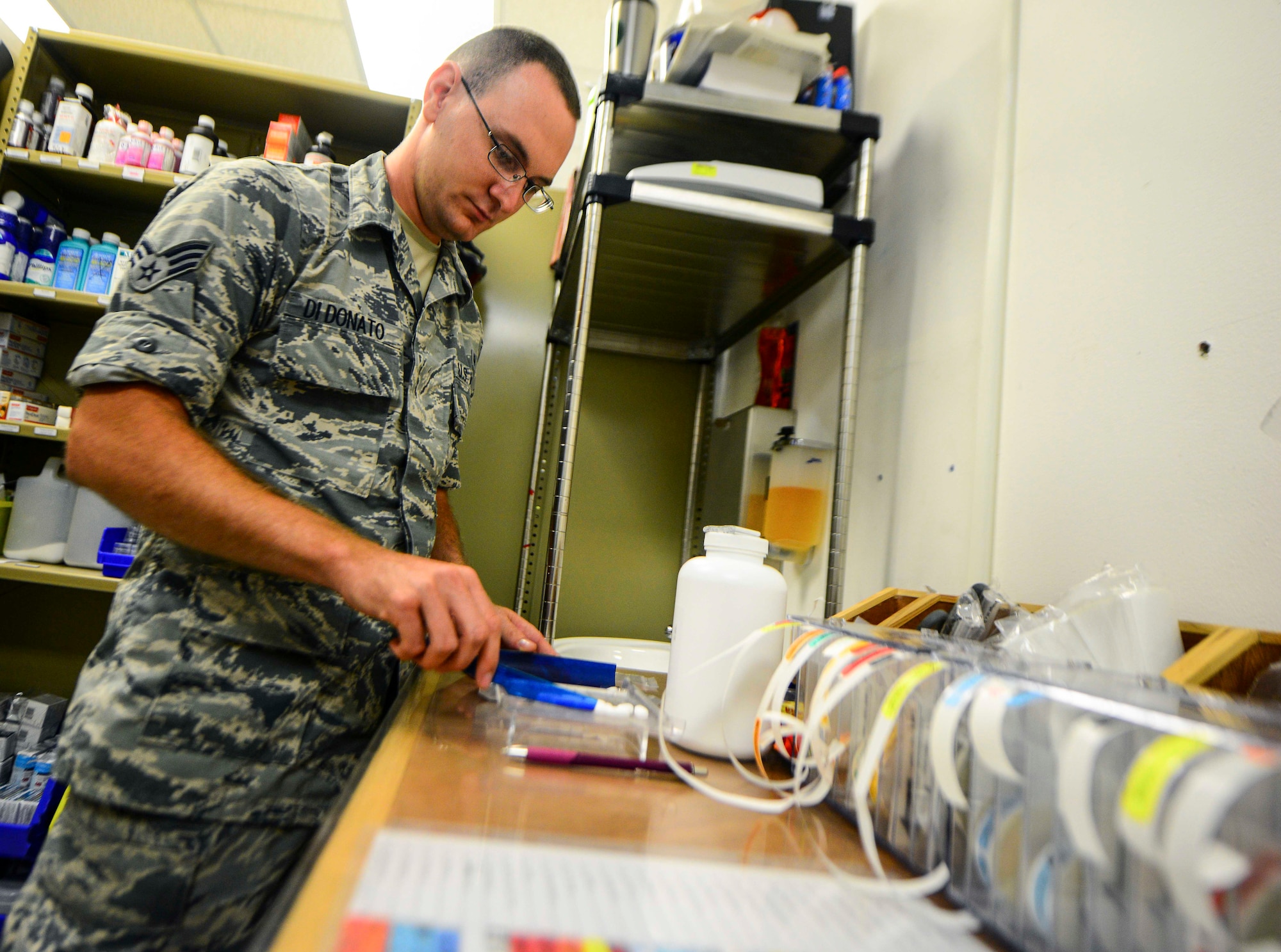 Senior Airman Timothy Di Donato, 379th Expeditionary Civil Engineer Squadron force protection escort, counts medicine tablets Oct. 4, 2016, at Al Udeid Air Base, Qatar. Di Donato, a pharmacy technician at Tyndall Air Force Base, Fla., volunteers to assist the pharmacy on base. The pharmacy serves members stationed here, Camp As Sayliyah and transient Aeromedical Evacuation patients from across the U.S. Air Forces Central Command area of responsibility. (U.S. Air Force photo/Senior Airman Janelle Patiño/Released)