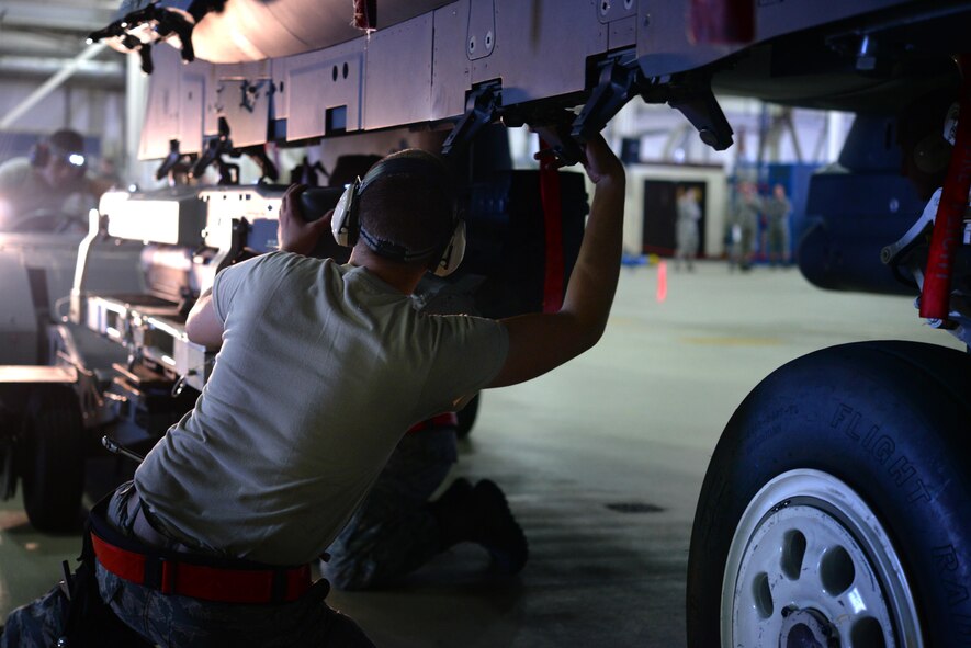 U.S. Air Force Airman 1st Class Kendall Hering, 494th Aircraft Maintenance Unit weapons load crew member, loads ammunition onto an F-15E Strike Eagle at Royal Air Force Lakenheath, England, Oct. 6. The ammunition was loaded as part of a quarterly load crew competition. The 48th Maintenance Group holds the competitions to give Airmen a chance to show off their technical prowess to peers and wing leadership. (U.S. Air Force photo/Airman 1st Class Eli Chevalier)