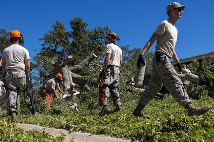 U.S. Air Force civil engineers with the 628th Civil Engineer Squadron, remove a fallen tree after  Hurricane Mathew swept through Hunley Park-Air Base housing, S.C., Oct. 9, 2016.   All non-essential personnel evacuated the area, but returned after disaster response coordinators assessed damage and verified a safe operating environment. 